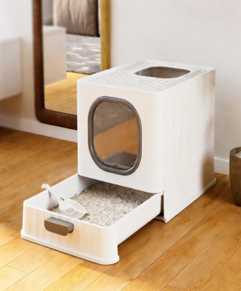 Maison de toilette pour chat blanc et gris avec le tiroir ouvert et une pelle 