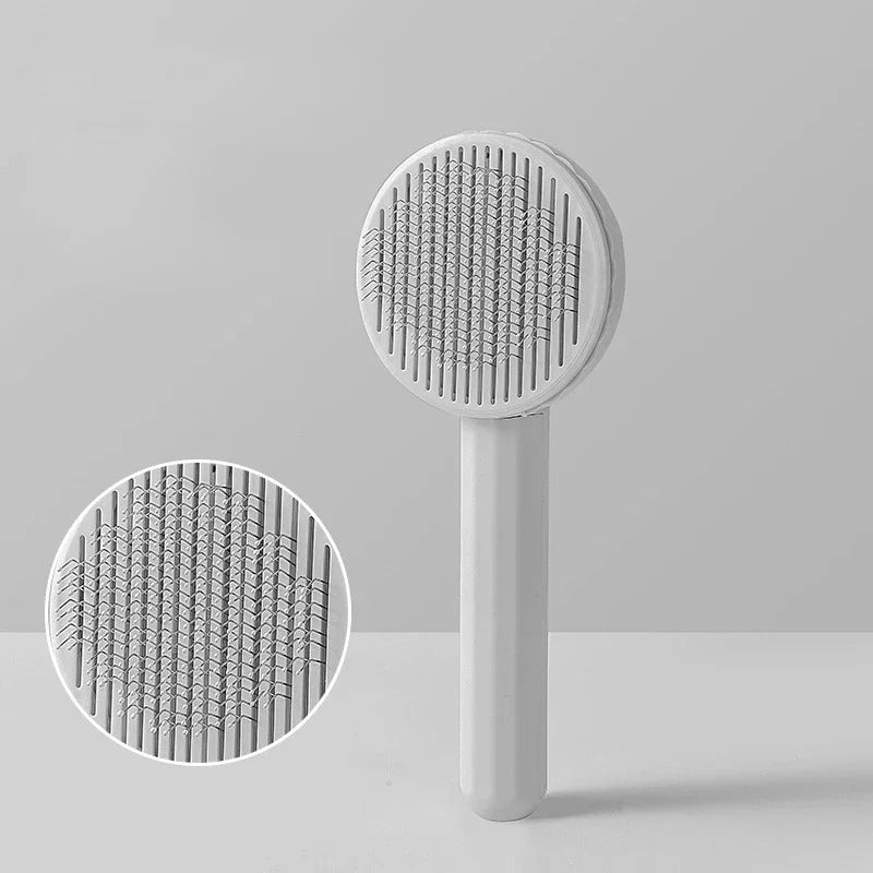 Brosse pour Chat blanche à tête ronde, avec gros plan sur les picots métalliques.